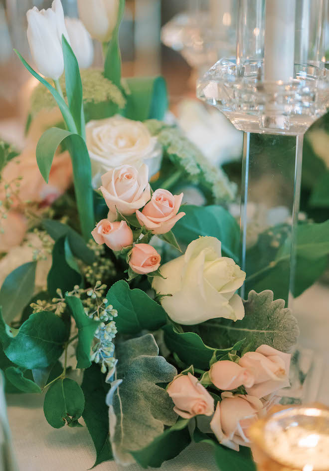 White, light blush pink, and sage lush greenery floral fill the reception tables throughout the wedding. 