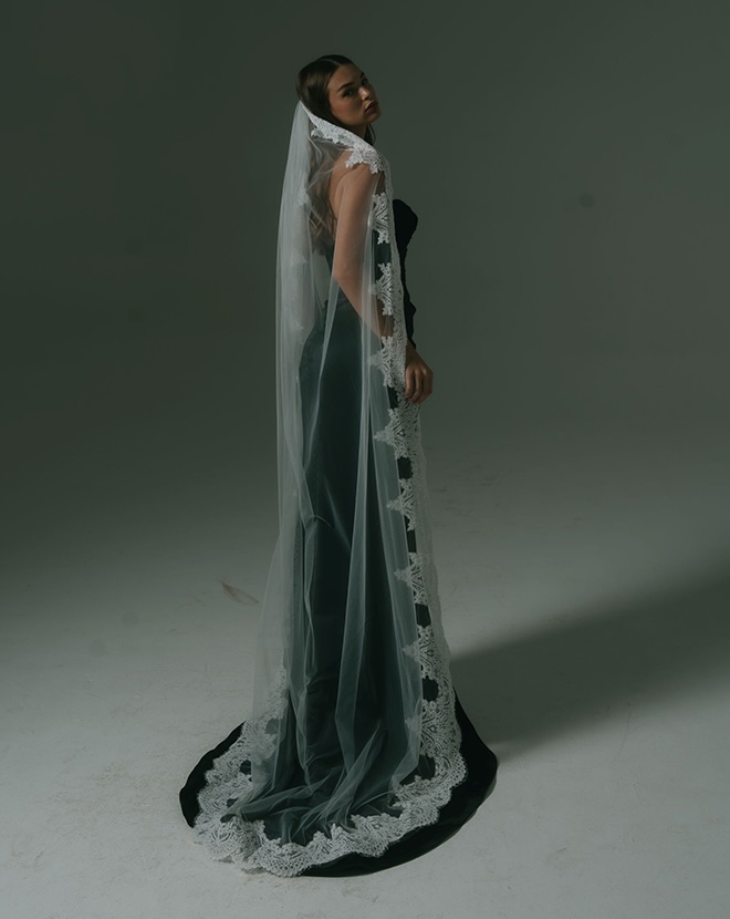 The model wears a black wedding dress by Hera Couture and a white veil.