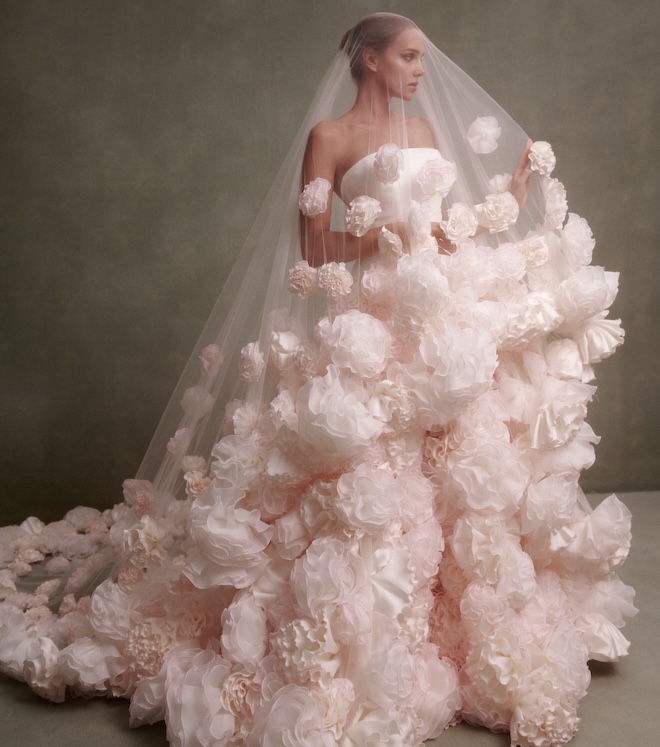 Bride wearing a strapless gown and veil with flower contrast stitching