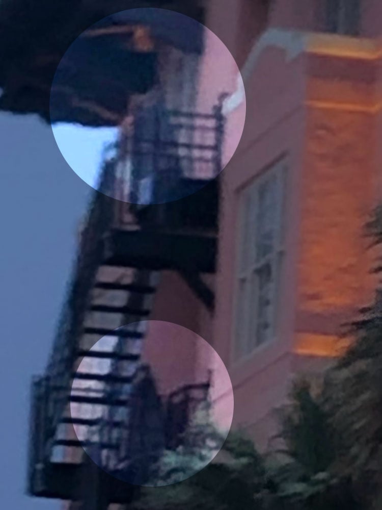 Two ghosts highlighted outside the Grand Galvez on a stairwell. 