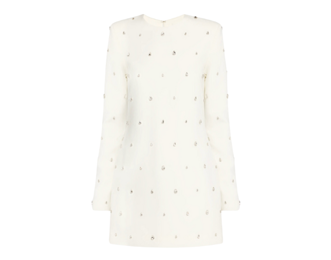 A white long sleeve mini dress embellished with jewels. 