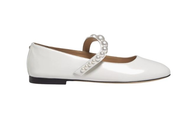 Chic satin white ballerina flats featuring a pearl strap. 