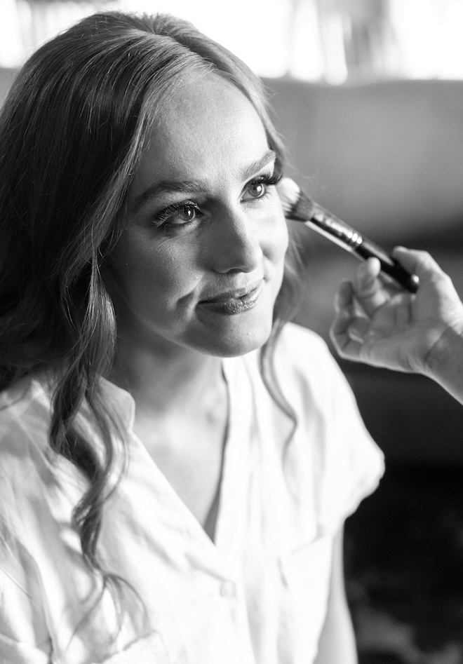 The bride getting her makeup done. 