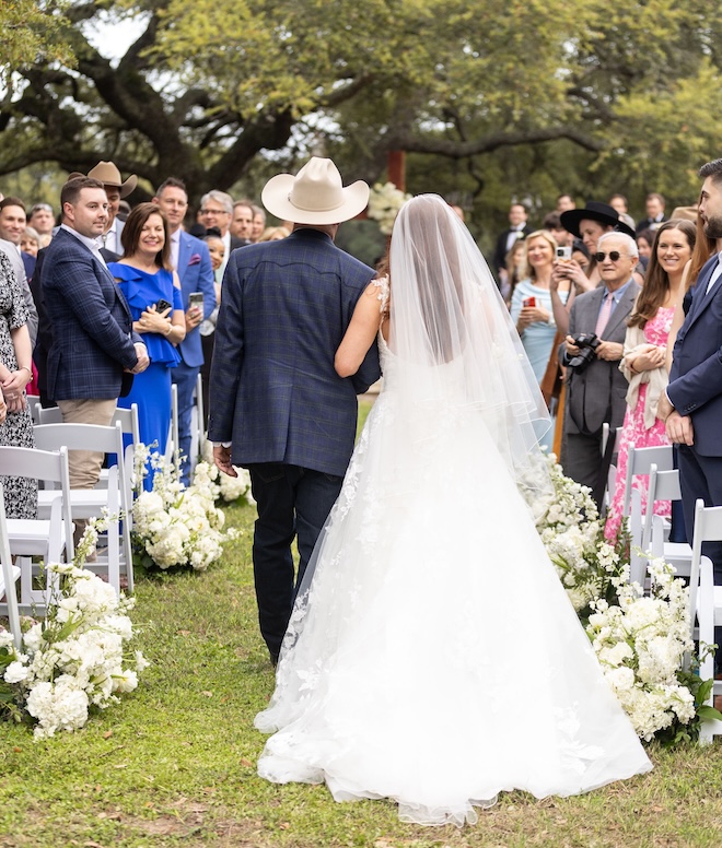 The bride and her father walking down the aisle. 