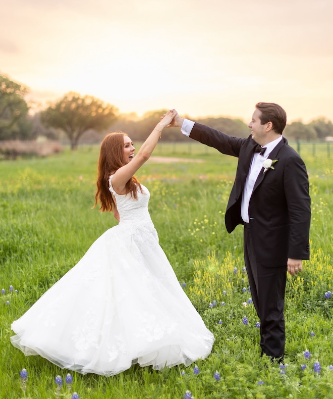 The bride and groom dancing in the wildflowers at their private ranch wedding. 