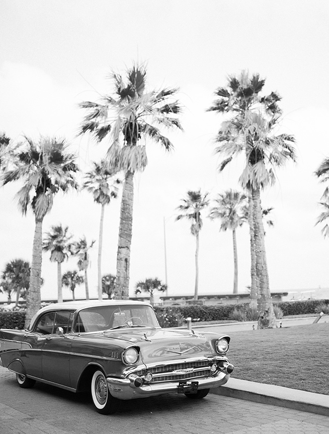 A light blue 1957 Chevrolet Belair sits outside the Grand Galvez as the bride and groom's getaway car. 