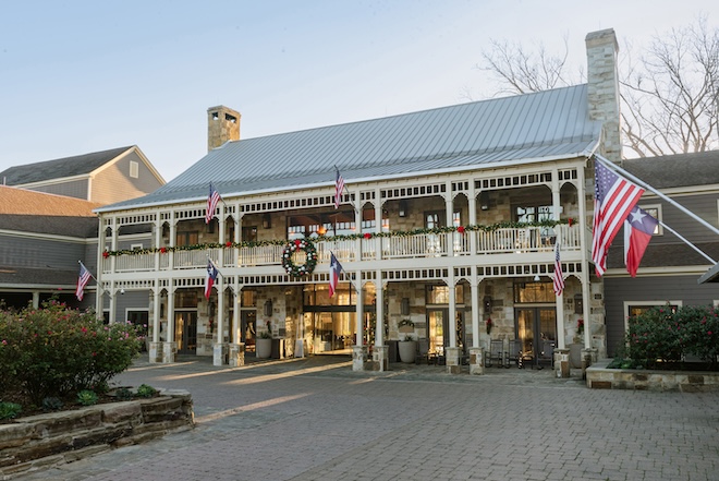 The exterior of Hyatt Regency Lost Pines Resort & Spa decorated with a holiday wreath and garland. 