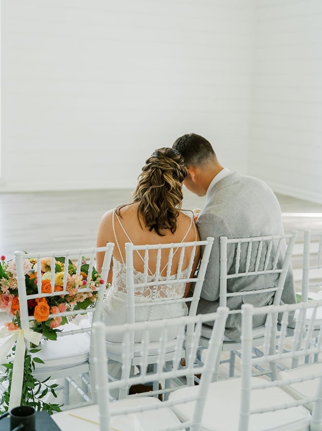 The bride and groom share private vows before their wedding ceremony. 