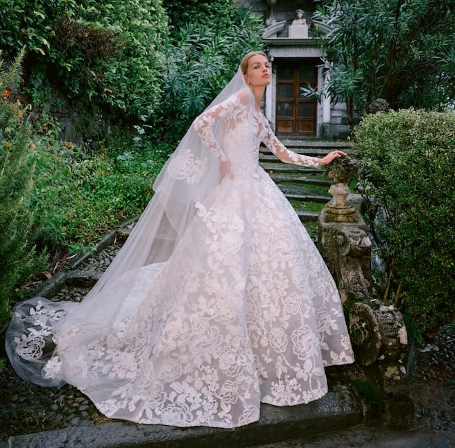 Ivory raffia flower lace strapless drop waist ball gown with softly structured skirt and matching jacket. 