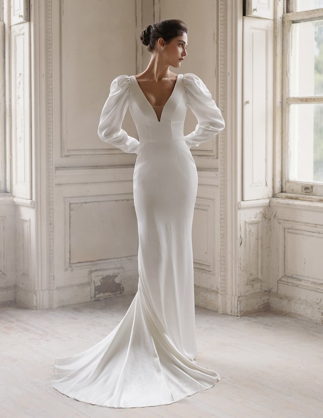 A satin column dress with a v-neckline and puffy long sleeves. 