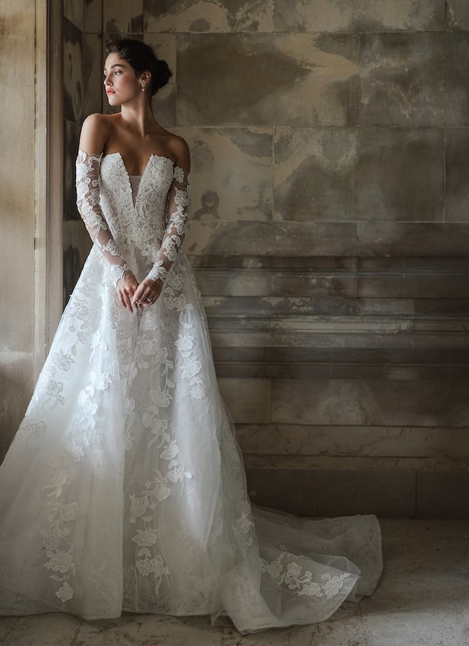 A structured strapless gown with floral embroidery with matching gloves. 