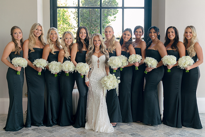 The bridesmaids wear emerald green dresses for the bride's wedding day. 