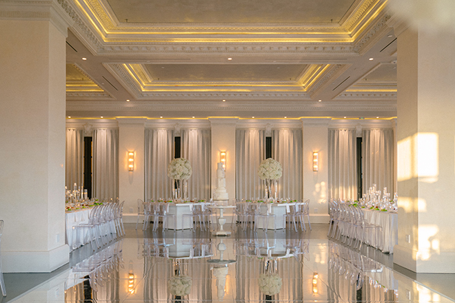 White florals and candlelight decorate the reception tables at the Gatsby-inspired wedding. 