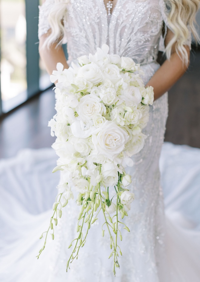 The bride's bouquet of all white florals and light greenery. 