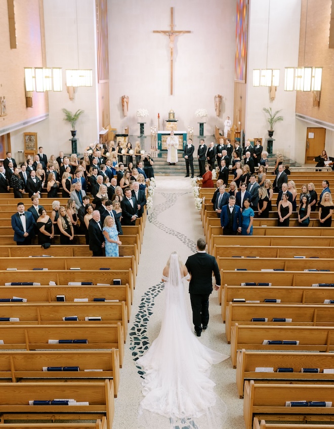 An aerial view of the bride and her father walking down the aisle. 