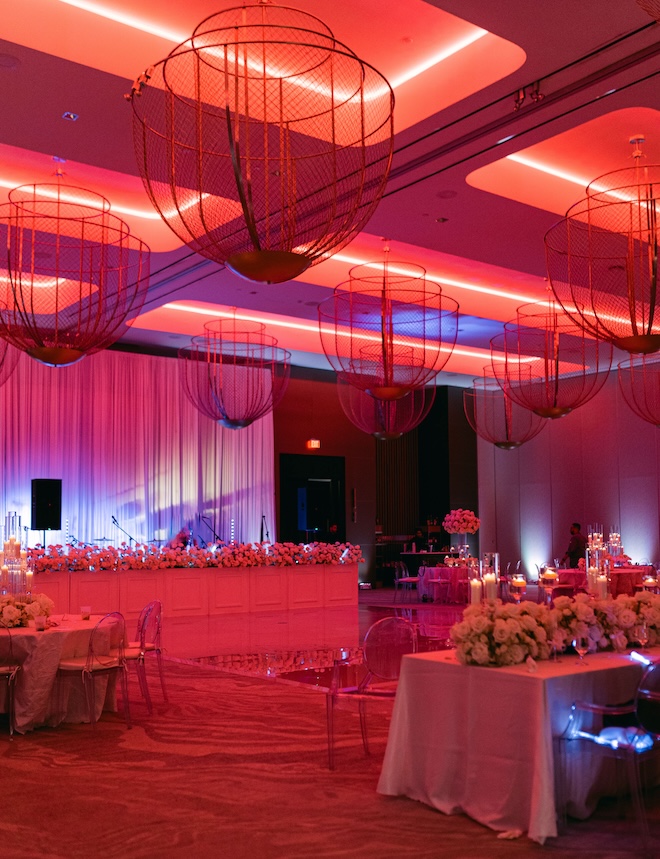 The ballroom at Thompson Houston, by Hyatt with red lighting for the reception. 