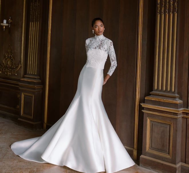 A satin dress with a lace long-sleeve overlay on the top.