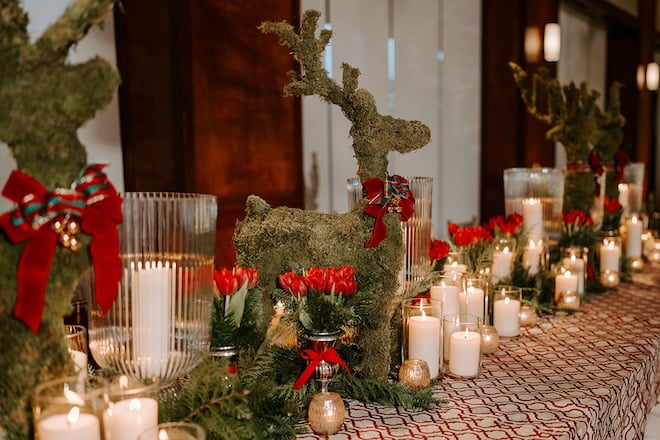 Grass reindeer and candlelight decorating the reception tables. 