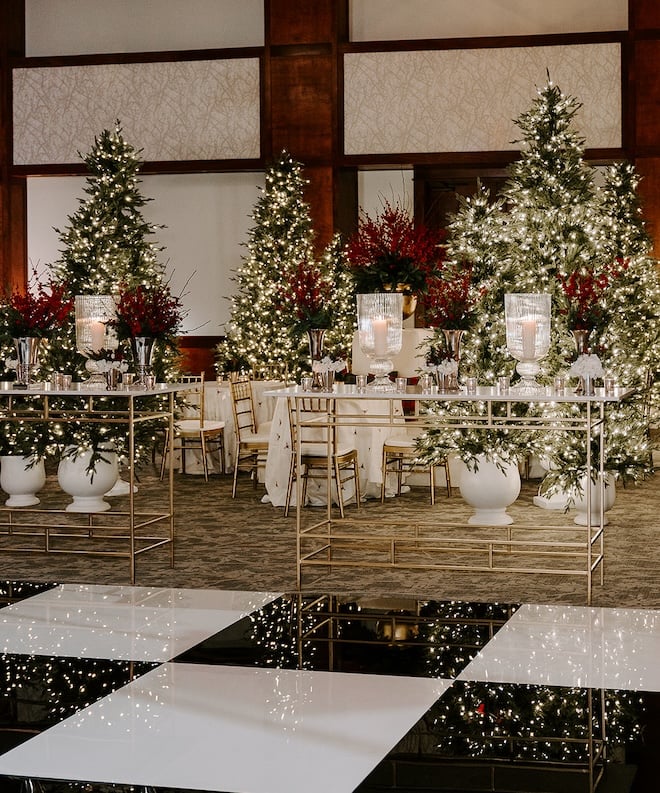 Christmas trees and red foliage decorating the ballroom. 