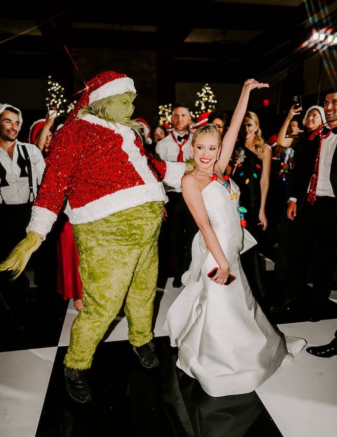 The bride dancing with the Grinch. 