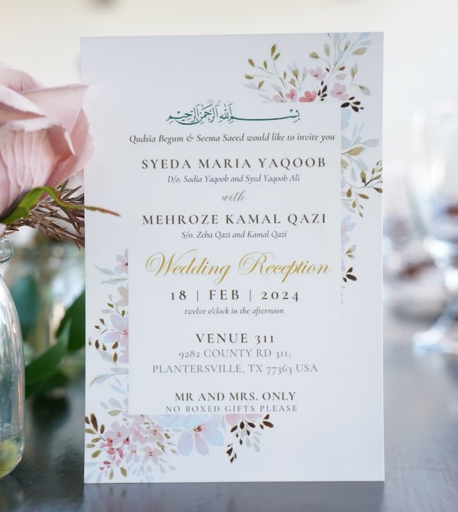 An invitation suite for Maria and Mehroze's wedding decorated with a floral print. 