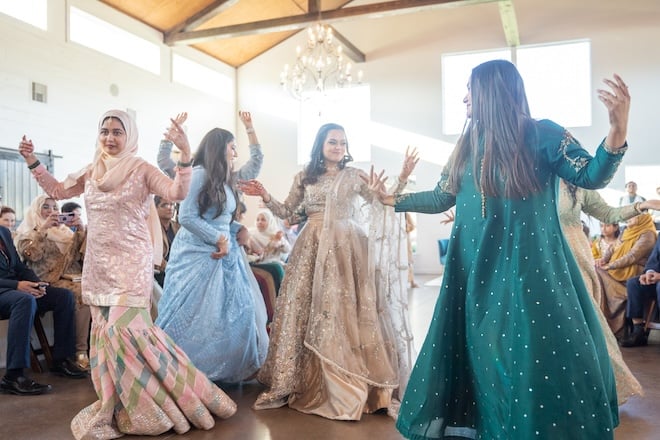 The bride and other women performing a dance at the reception. 