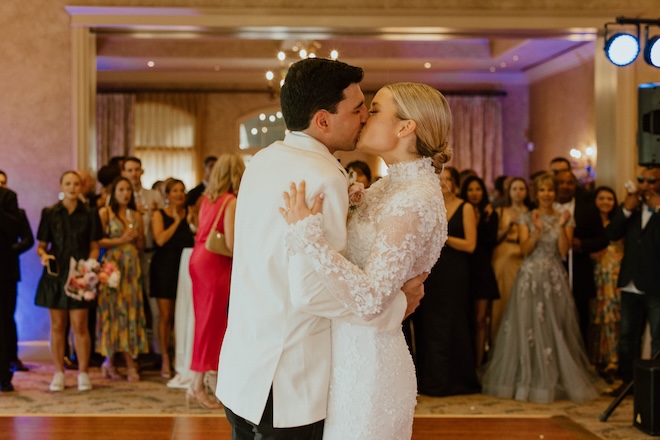 The bride and groom kissing on the dance floor in the Royal Oaks Country Club ballroom. 