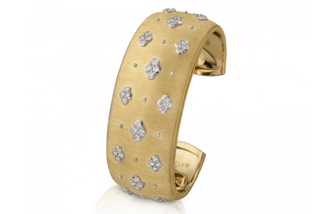 A gold cuff with diamonds. 