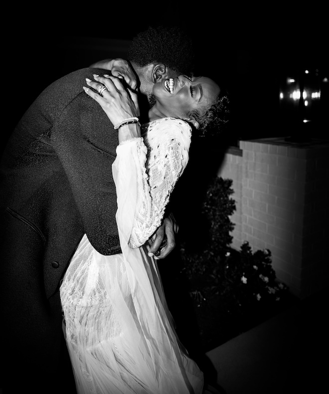 A black and white photo of the couple hugging. 