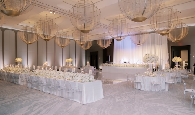 The ballroom at the Thompson Houston decorated with white florals and linens. 