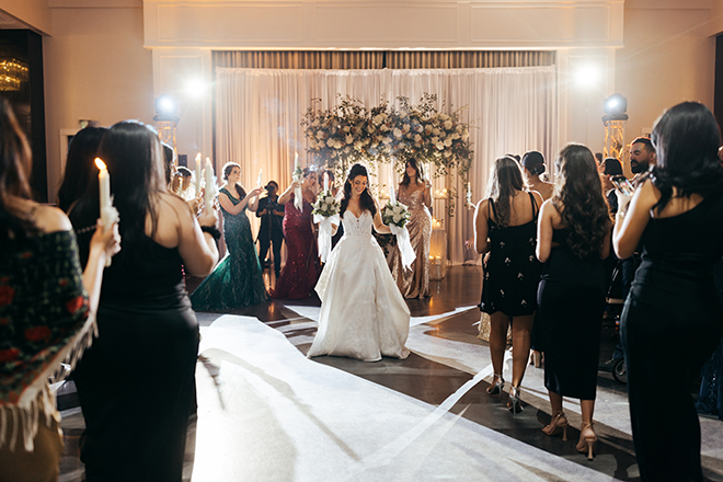 To honor her heritage, the bride does a traditional bridal candle dance at her reception.