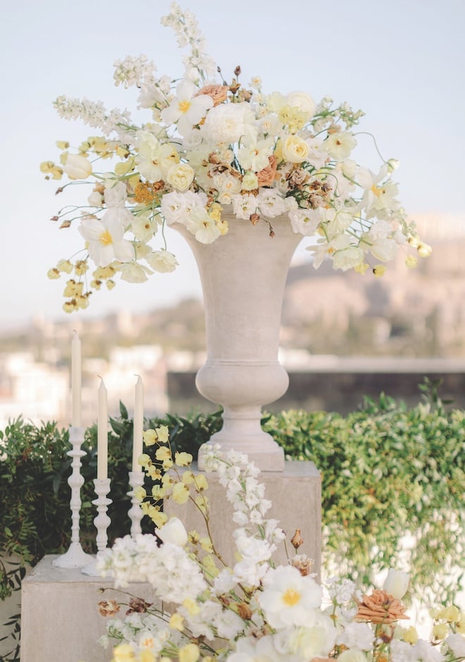 Floral arrangements full of yellow, white and orange flowers. 