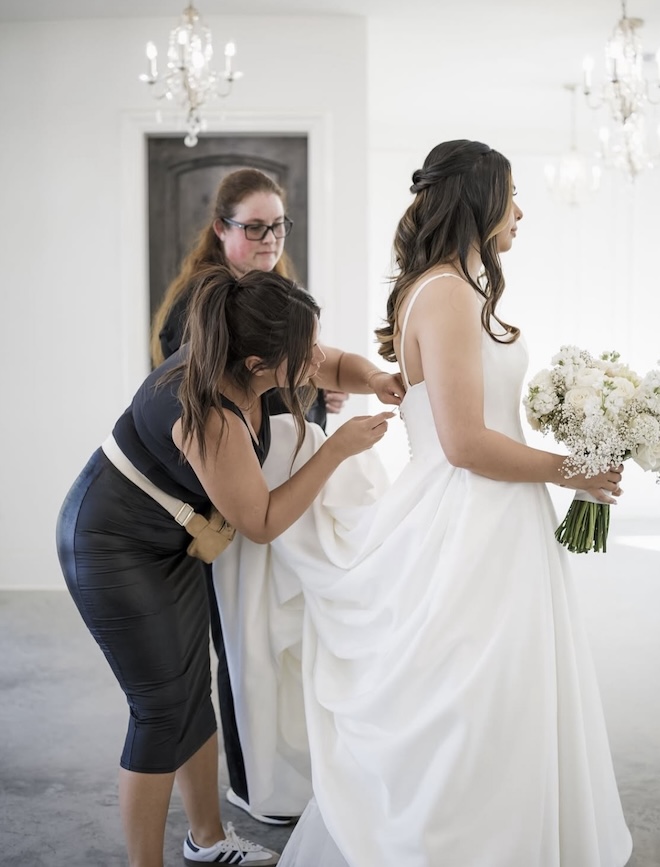 HQT Bridal Tailoring makes final adjustments to the brides wedding gown before her ceremony.