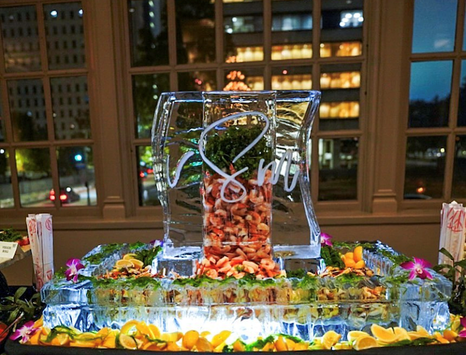 An engraved ice sculpture with shrimp inside. 