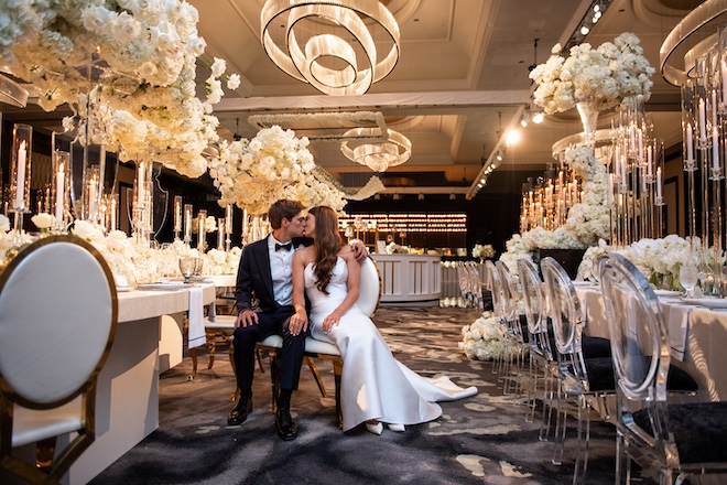 A bride and groom kissing in the ballroom of the Post Oak Hotel at Uptown Houston. 