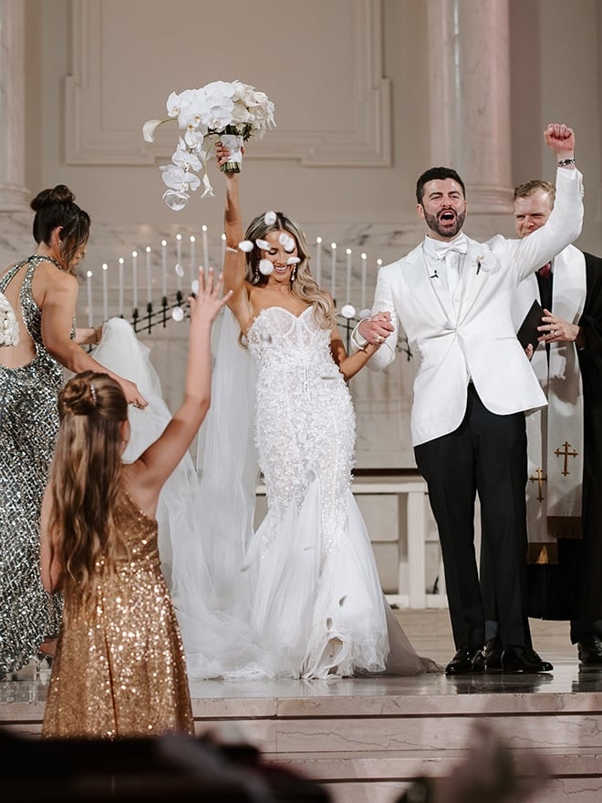 The bride and groom cheer on the altar after their wedding vows. 