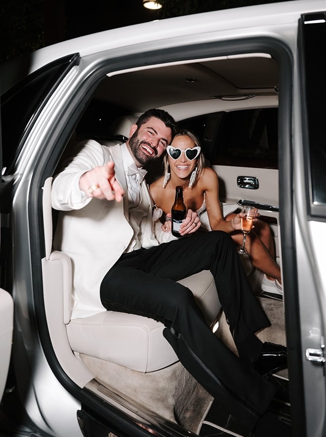 The bride and groom ride off in a white limo from their wedding reception in Houston. 