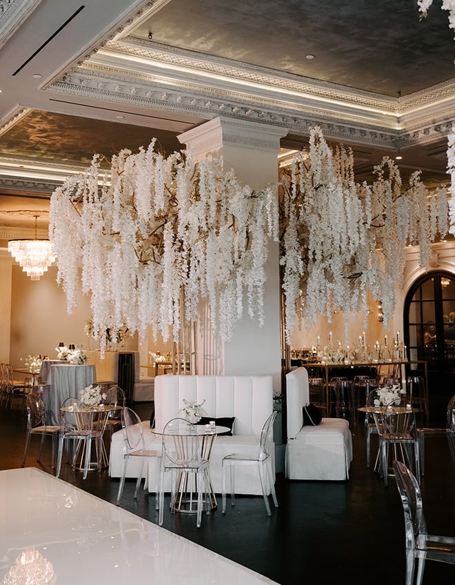 White wisteria detail and flowers detail the reception. 