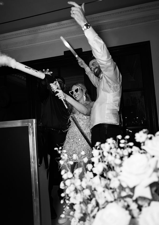 The bride and groom dance on stage at their wedding reception. 