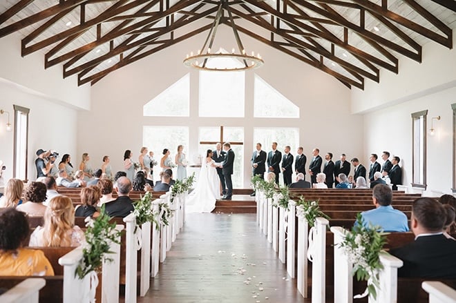 The bride and groom exchange vows at the altar at during their chapel ceremony. 