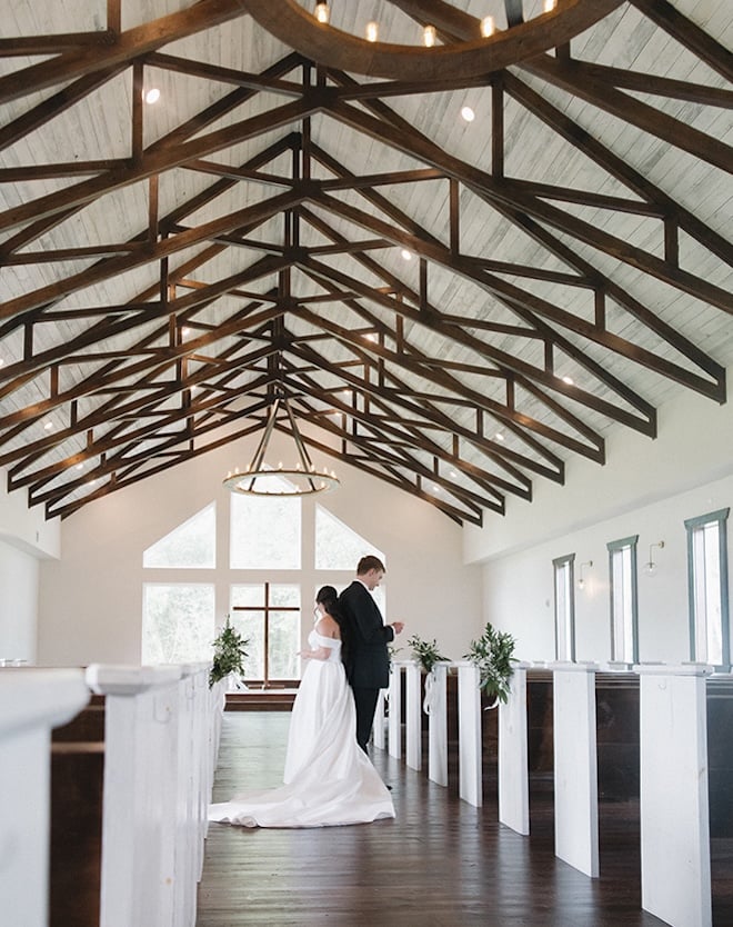 The bride and groom share private vows in the chapel before their wedding ceremony. 