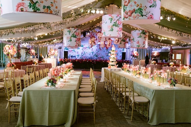 White and green drapes decorate the ceiling at the wedding reception. 