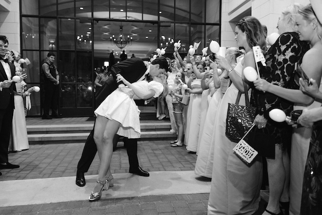 The groom dipping the bride and kissing her during their send-off. 