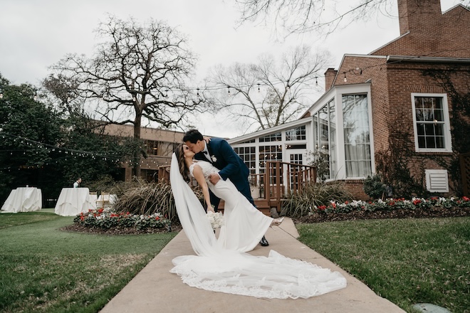 The bride and groom kissing in front of The Houstonian Hotel, Club & Spa. 