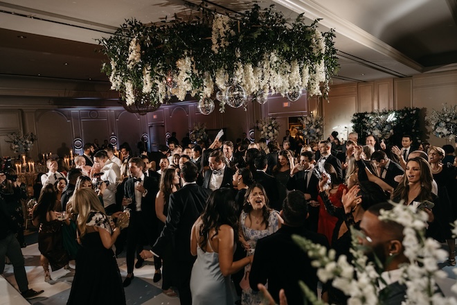 A lush hanging garden full of greenery, white florals and disco balls. 