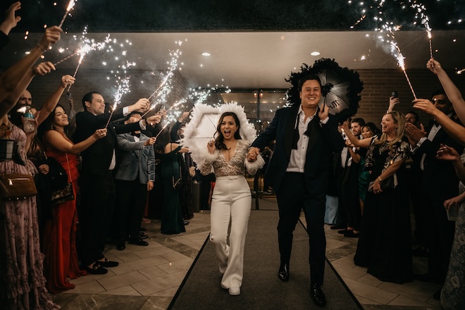 The bride and groom's second-line exit with black and white umbrellas and sparklers. 