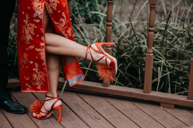 The brides red high heels with a feathered toe. 