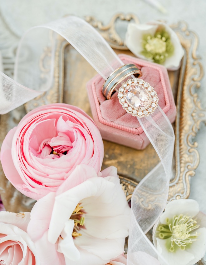 Wedding bands from Tenenbaum Jewelers are placed in jewelry holders. 