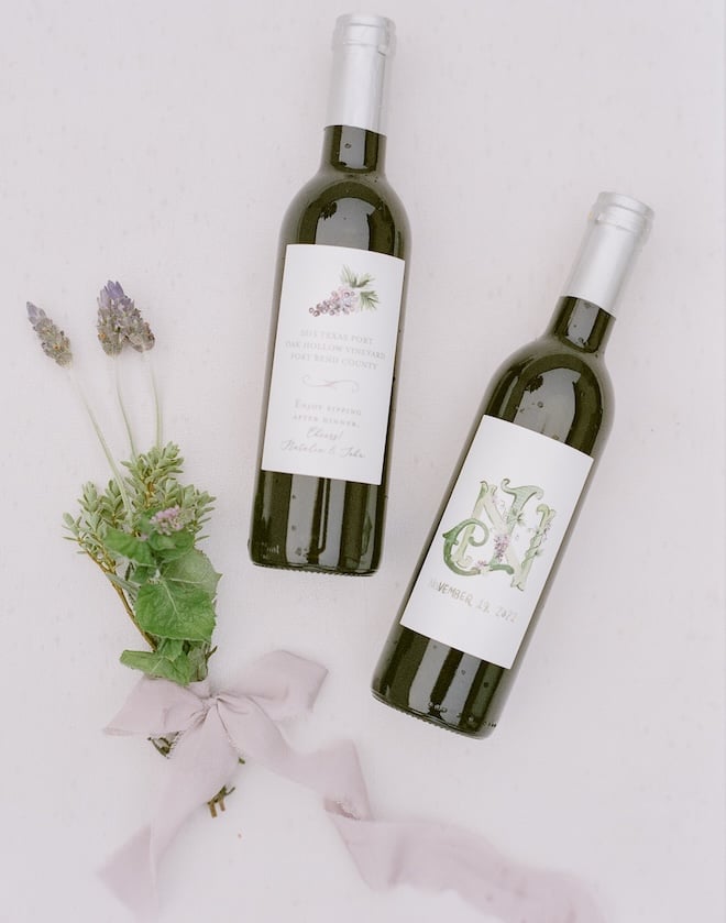 Wine bottles are detailed in custom labels for the bride and groom's wedding day.