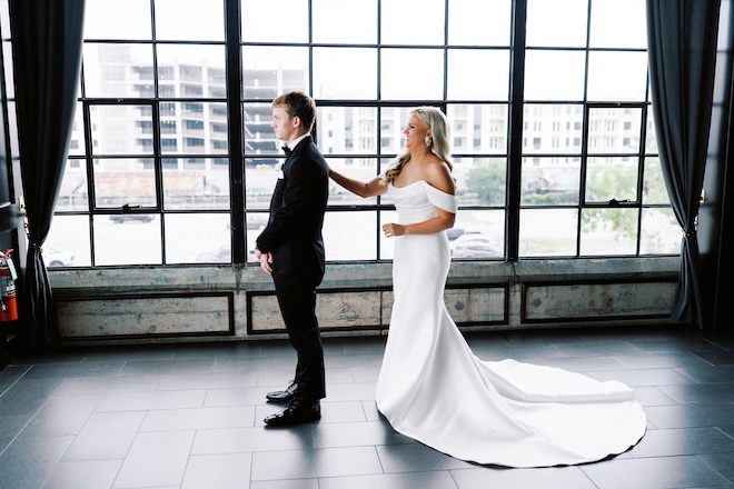 The bride tapping the groom on the shoulder for their first look. 